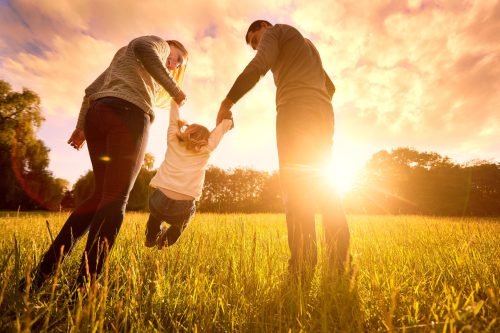 Family Playing with Child Sunset Outdoors